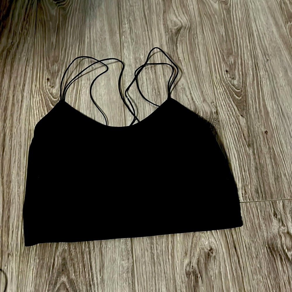black crop top. it has a flower lace pattern on the back